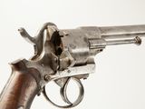 an old gun with a wooden handle on a white background