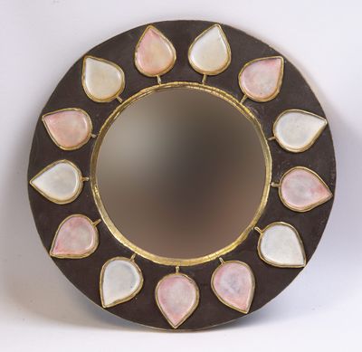 un miroir rond orné de pierres roses et blanches