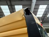 a large yellow truck parked inside of a building
