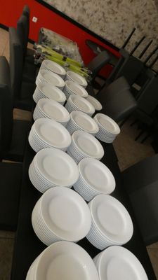 a long table with many plates on it in a room