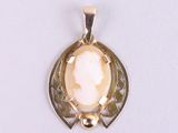 an image of a gold pendant with a white stone in the center