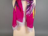 a pink and yellow scarf on a mannequin mannequin