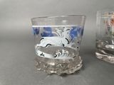 two shot glasses sitting next to each other on a table