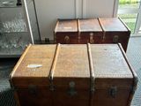 three trunks sitting on the floor in a room