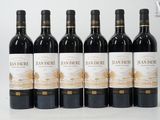 six bottles of red wine are lined up in a row