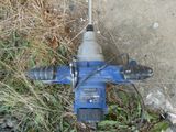 a blue drill that is laying on the ground