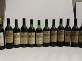 several bottles of wine are lined up in a row on a table