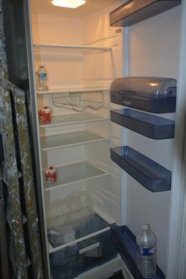an open refrigerator with a lot of food inside of it