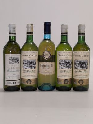 four bottles of wine are lined up in a row on a table