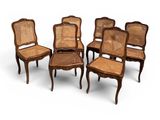 a set of six chairs with cane backrests and cane backrests