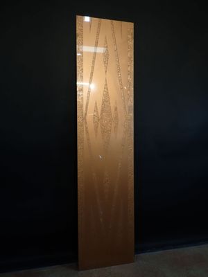 a tall metal sculpture in a dark room with a black wall