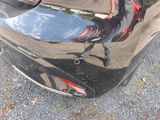 a reflection of a person in the rear of a car