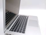 a white laptop with a black keyboard on a white surface
