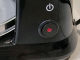 a black blender sitting on top of a counter next to a bowl