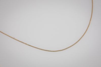 a gold chain necklace with a diamond clasp on a white background