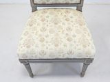 a chair with a floral upholstered seat and back