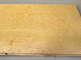 an old book with a wooden cover sitting on top of a table