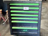 un chariot à outils noir et vert dans un garage