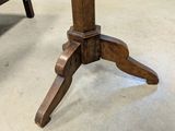 a wooden table with a glass top and a wooden base