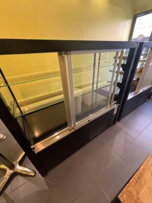 a glass display case in the middle of a room