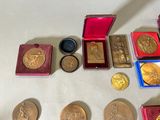 a lot of gold and silver medals on a table