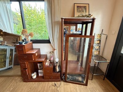 a wooden display case with a mirror on top of it