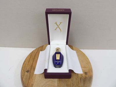a bottle of perfume sitting in a box on a table