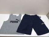 two pairs of shorts and a t - shirt are on a table