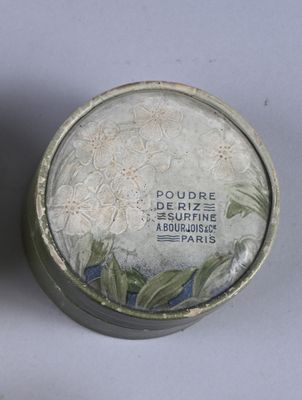 two tins that have flowers on them on a table