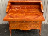 an image of a wooden desk with drawers on it