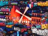 a windmill in the middle of a city covered in graffiti
