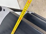 a measuring tape on the side of a piece of metal