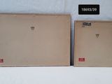 two empty boxes sitting next to each other on a white surface
