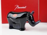 a black elephant figurine sitting in front of a red box