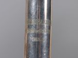 a metal object with writing on it sitting on a table