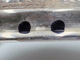 a close up of a piece of metal with holes in it