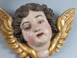 a statue of an angel with wings on a wall