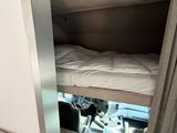 a bunk bed in the corner of a small room
