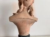 marble bust of a lion on a pedestal in front of a painting