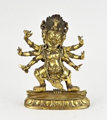 a gold statue of a person on a pedestal with a white background