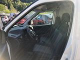 a white van with the door open and the driver ' s seat down