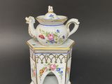an image of a teapot with a bird on top of it
