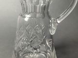 a glass pitcher that is sitting on a table