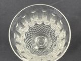two clear glass bowls sitting on top of a black surface