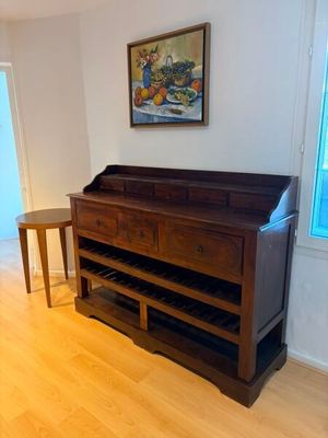 hardwood flooring in a living room with a table and a painting on the wall