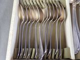 a lot of spoons and forks in a box