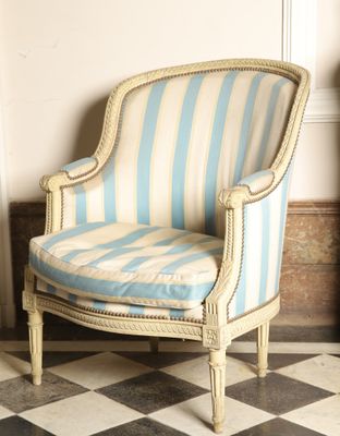 a chair that is sitting in a room with a black and white checkered floor