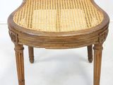 an image of a chair with a cane back on a white background