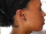 a woman with a pair of ear piercings on her ear