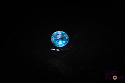 an image of a blue glass ball in the dark